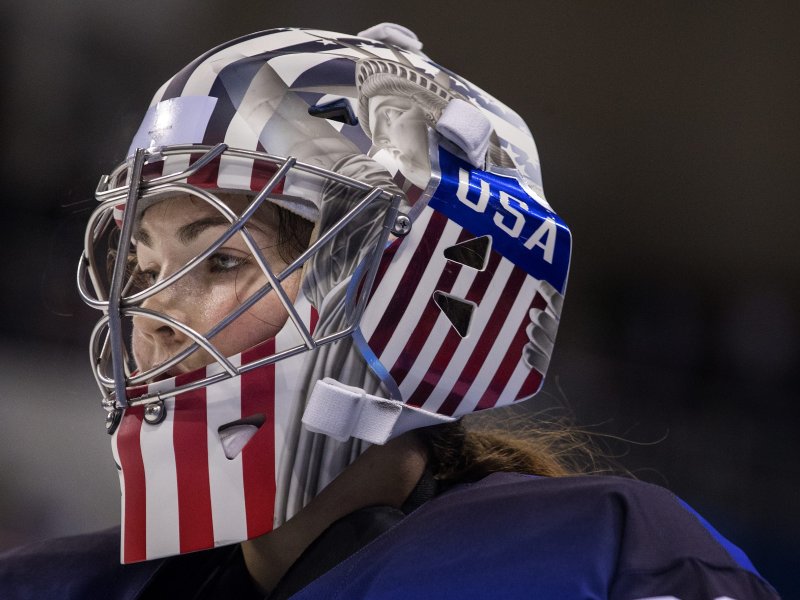 A woman wears a helmet with the Statue of Liberty and the American flag