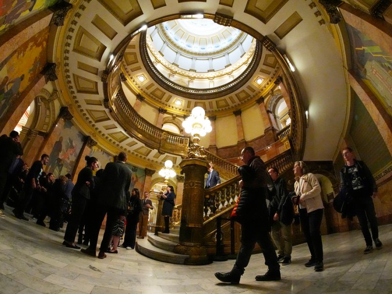 A group of people walk through the Capitol building