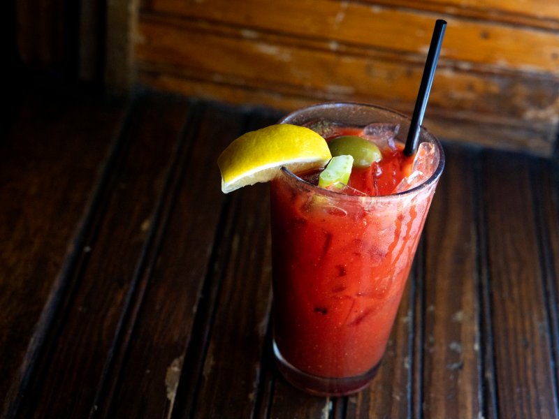 A Bloody Mary cocktail sitting on a bar