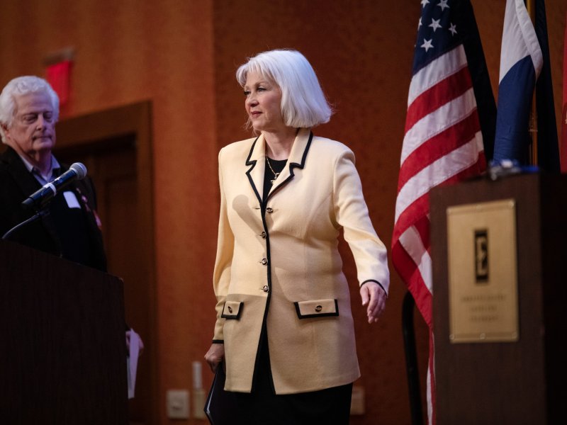 A woman walks up to a mic.