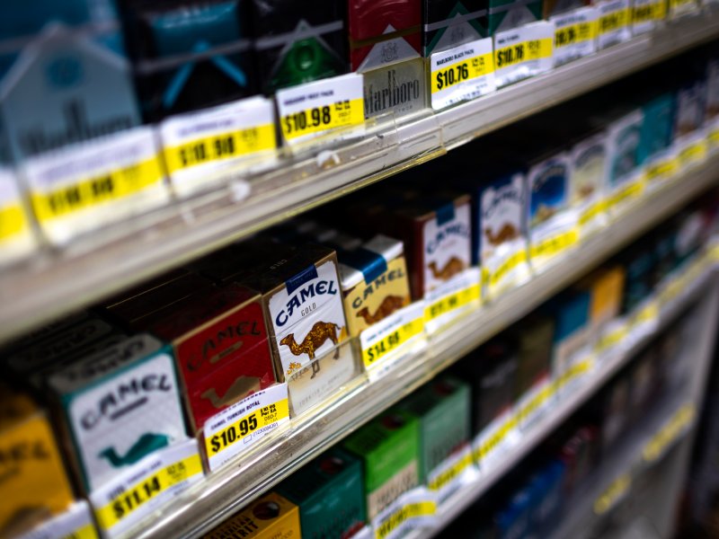 Rows of cigarette boxes with yellow price tags