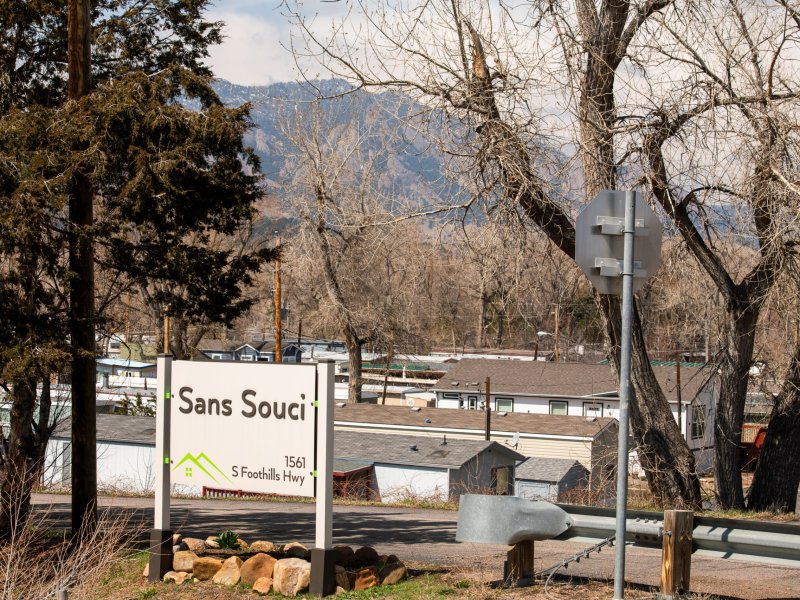 A sign reads "San Souci." The tops of roofs are seen in the background