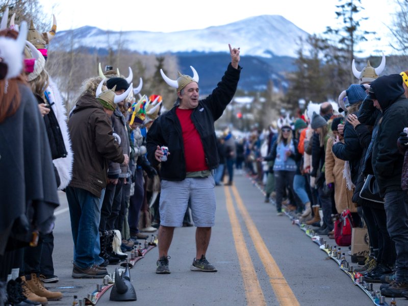 People in winter outwear with horned viking hats at the Ullr Fest.