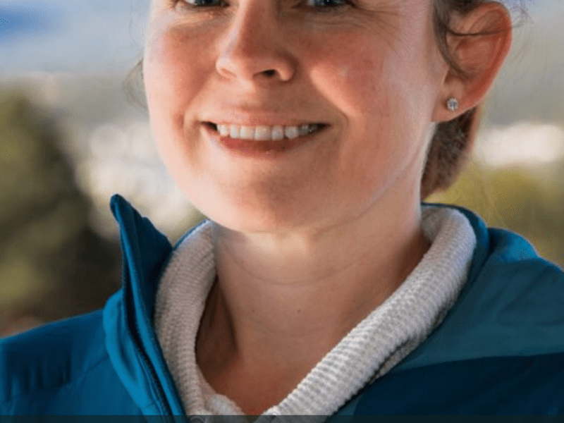 A woman wearing a blue jacket smiles outdoors. The text reads "Kate Merlin - WildEarth Guardians' Climate and Energy Program Colorado Attorney.