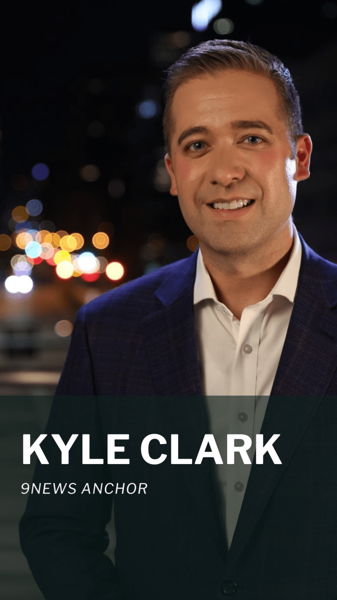 A person in a suit stands outdoors at night. The text on the image reads "KYLE CLARK, 9NEWS ANCHOR.